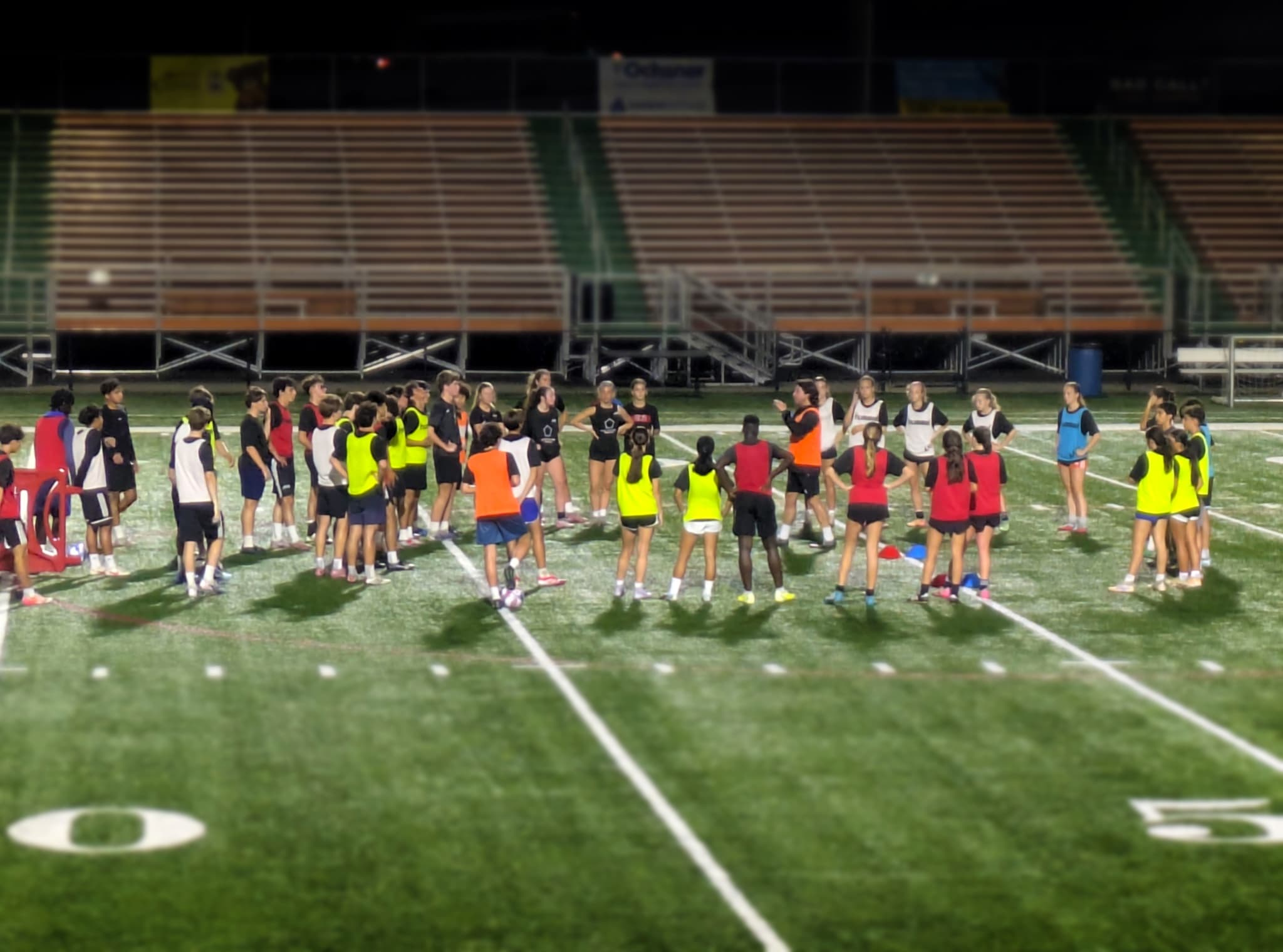 Players gathered under the lights at a City 7's night session